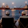 FILE PHOTO: Galaxy Globe bulk carrier and Luojiashan tanker sit anchored in Muscat