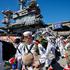 The US Navy Nimitz-class aircraft carrier USS Abraham Lincoln returns home following an extended deployment in the Middle East at Naval Base Coronado in San Diego