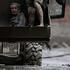 A survivor is transported to a safer place in heavy machinery following flash flood and mudslide at Trishuli