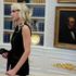 Natalie Harp, executive assistant to U.S. President Donald Trump, listens as Trump signs the Secure America Act