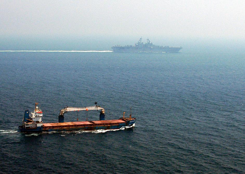 A merchant ship sails off the starboard side of amphibious assault ship USS Kearsarge (LHD 3) while transiting the Straits of Hormuz. Kearsarge is surge-deployed transporting elements of the 24th Marine Expeditionary Unit in support of Operation Iraqi Fre
