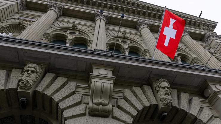 FILE PHOTO: A Swiss flag hangs at the Swiss Parliament building (Bundeshaus) in Bern