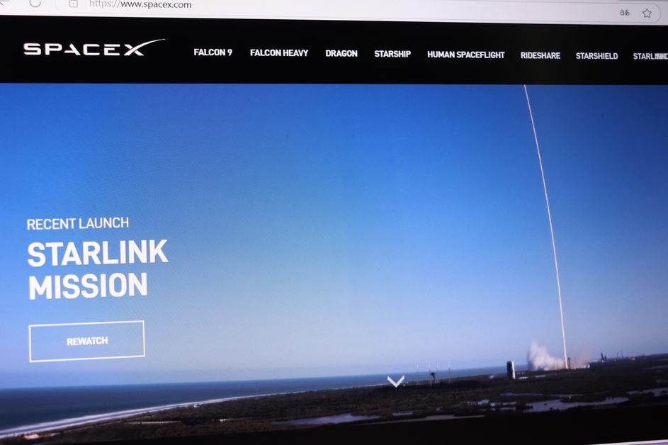 Spacex launch site with clear sky and visible rocket trajectory during starlink mission.